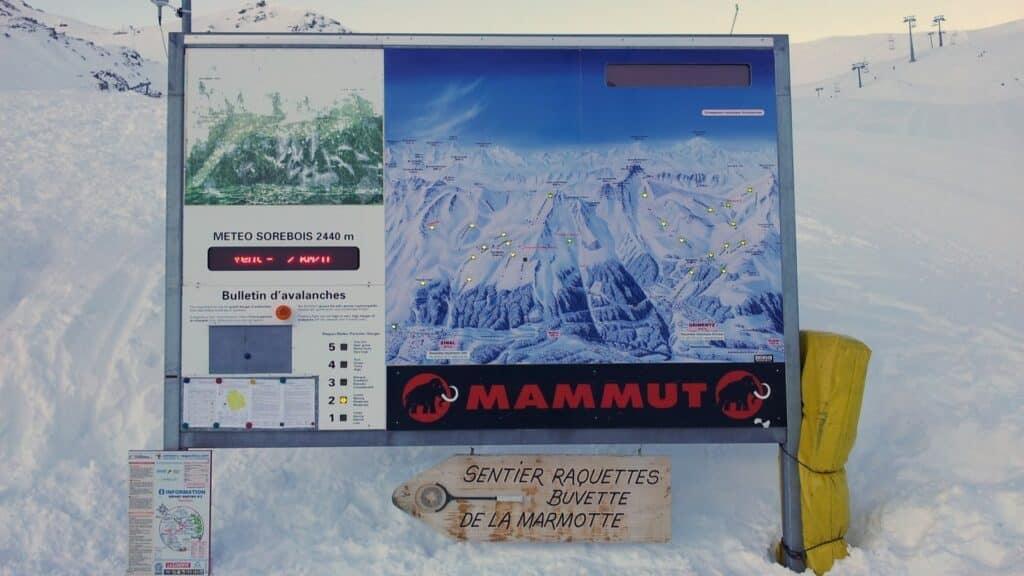 Panneau d'information sur les conditions météorologiques et les avis d'avalanches à Sorebois, Grimentz, affichant une carte des pistes de ski et des détails sur la sécurité en montagne.