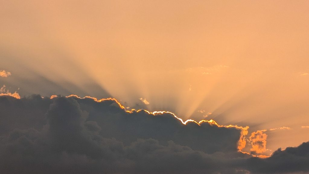 Rayons de soleil perçant des nuages sombres au crépuscule.